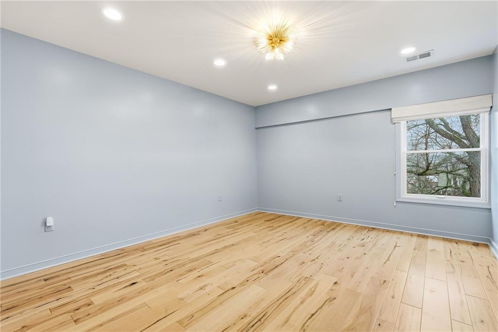 5742 Fifth Avenue, Unit 304 Pittsburgh, PA 15232 - Photo 26 of 32 wooden floor in an empty room with a window