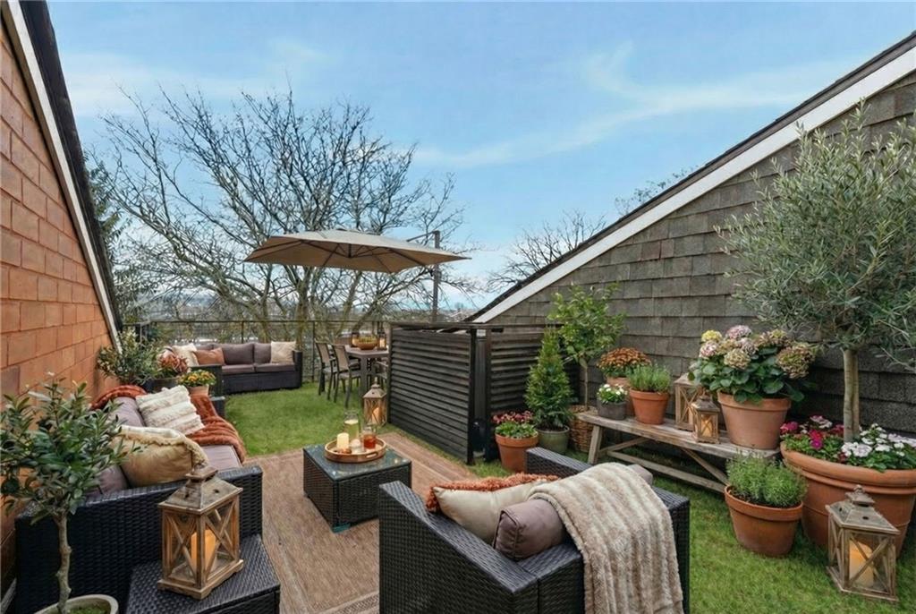 5742 Fifth Avenue, Unit 304 Pittsburgh, PA 15232 - Photo 30 of 32 a view of a patio with couches chairs and a potted plant