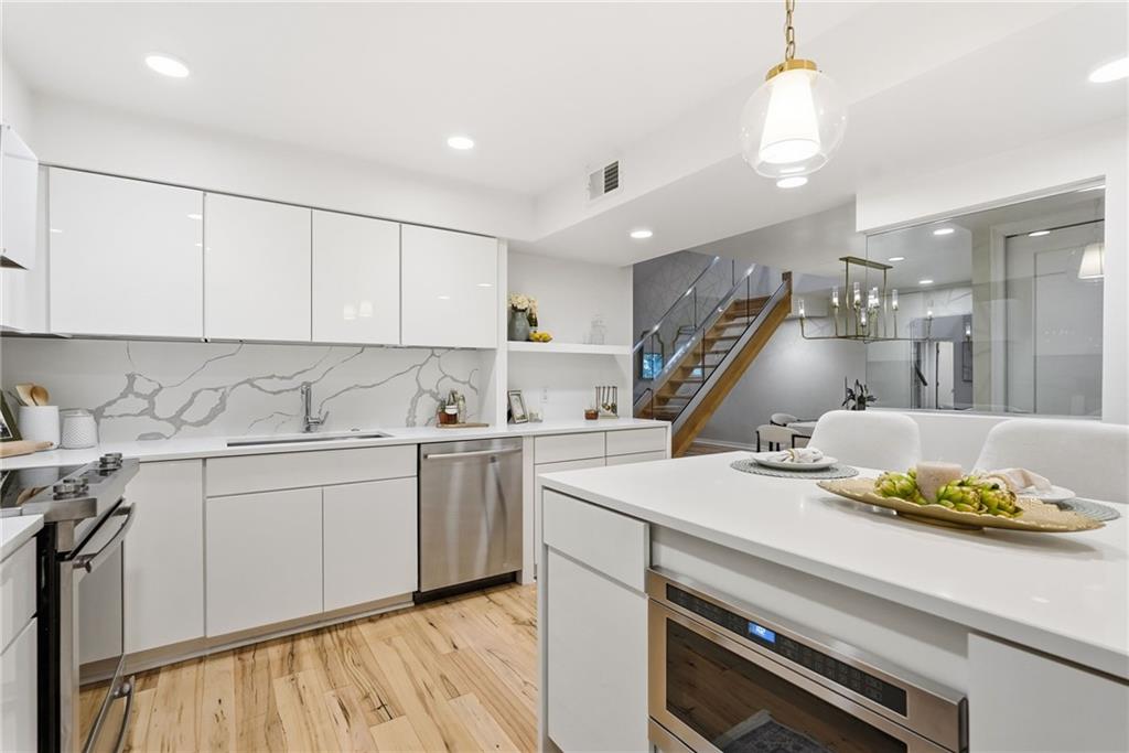 5742 Fifth Avenue, Unit 304 Pittsburgh, PA 15232 - Photo 6 of 32 a kitchen with a sink cabinets and wooden floor