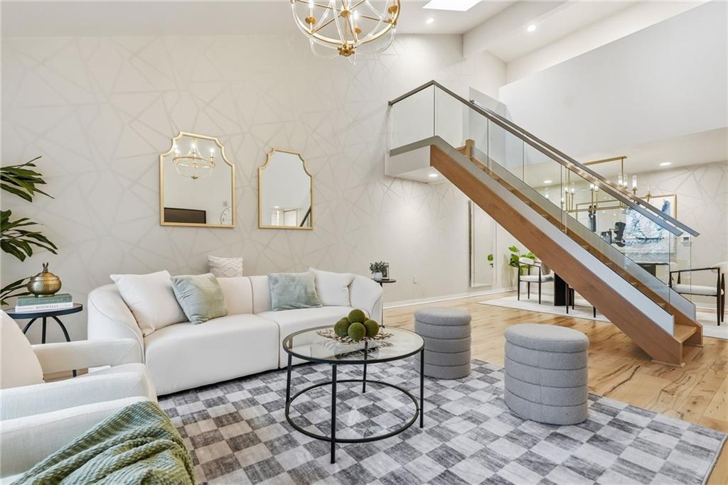 5742 Fifth Avenue, Unit 304 Pittsburgh, PA 15232 - Photo 9 of 32 a living room with furniture and a potted plant