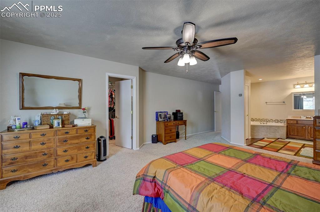 427 Ute Avenue Simla, CO 80835 - Photo 21 of 49 a bedroom with a bed and a flat tv screen on dresser