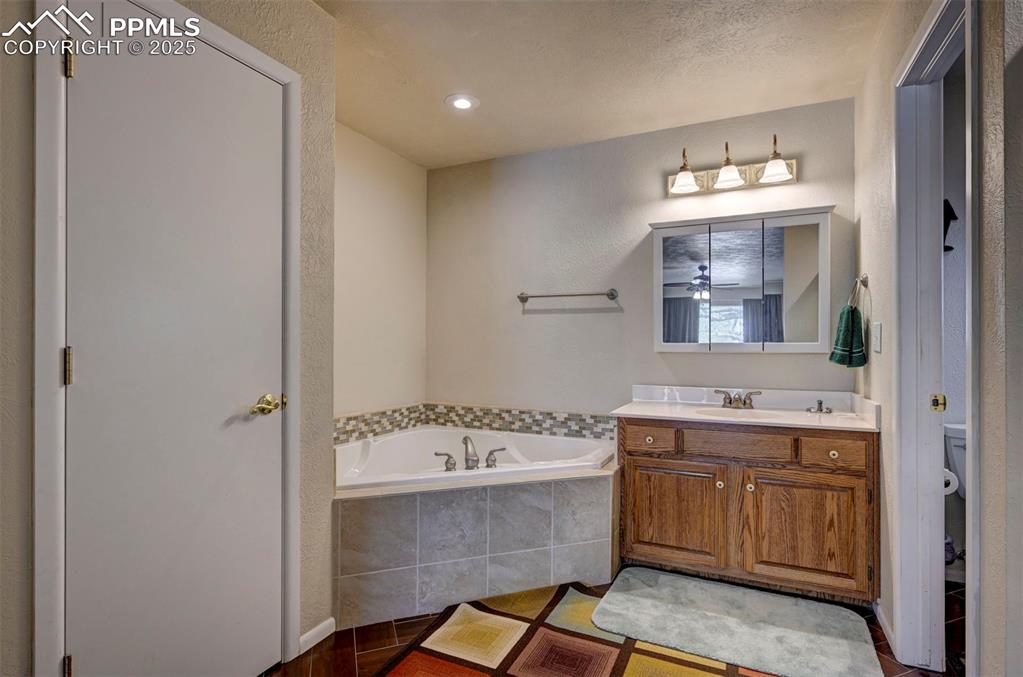 427 Ute Avenue Simla, CO 80835 - Photo 22 of 49 a bathroom with a tub a sink and a mirror
