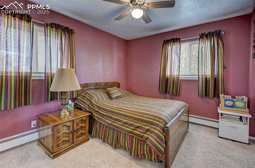 427 Ute Avenue Simla, CO 80835 - Photo 24 of 49 a bedroom with a bed and a chandelier