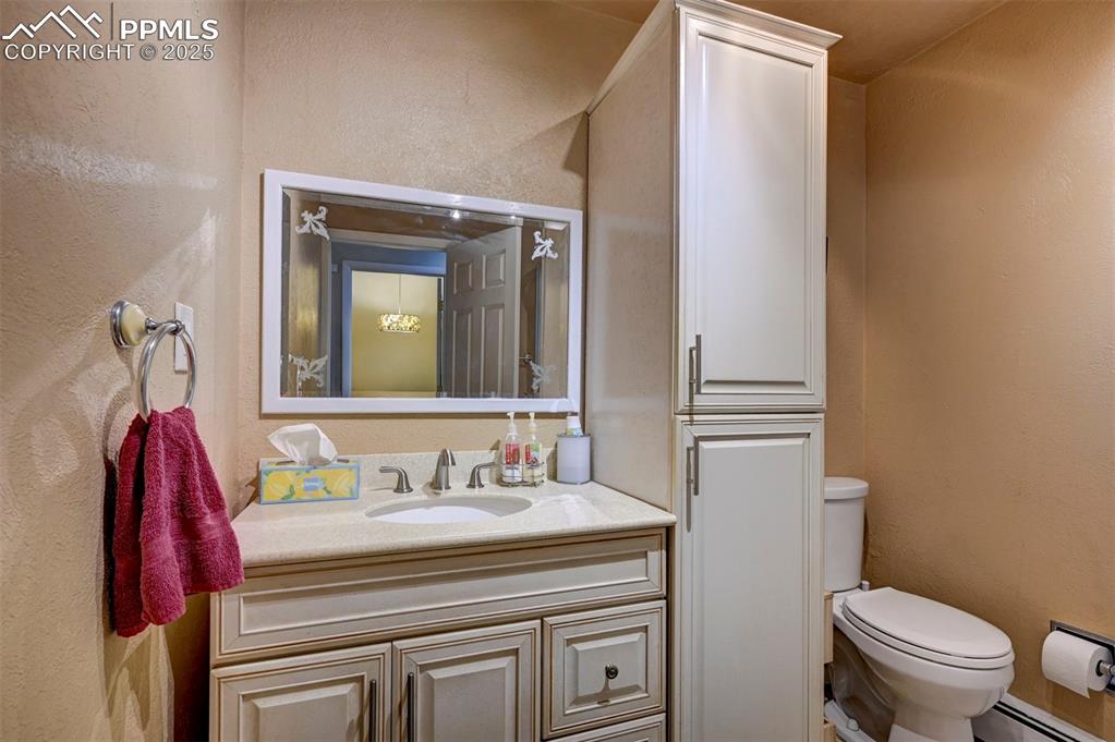 427 Ute Avenue Simla, CO 80835 - Photo 27 of 49 a bathroom with a sink a toilet and a mirror