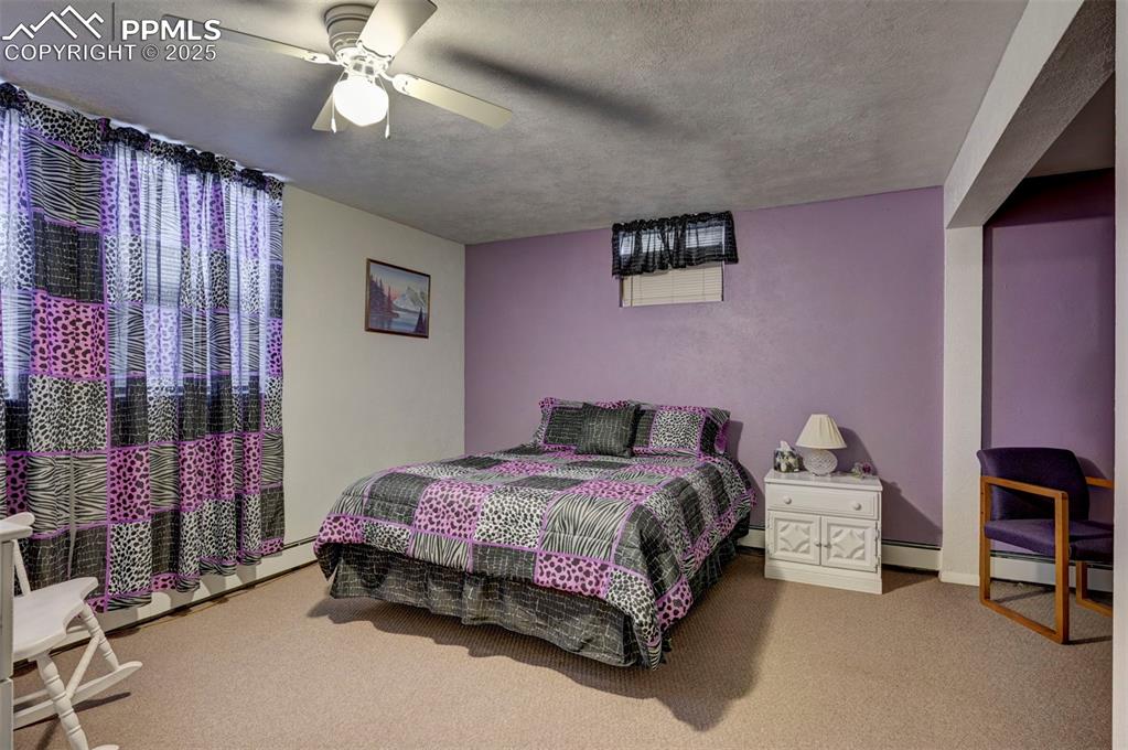 427 Ute Avenue Simla, CO 80835 - Photo 33 of 49 a bedroom with a bed and a ceiling fan