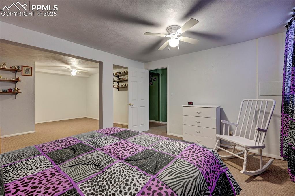 427 Ute Avenue Simla, CO 80835 - Photo 34 of 49 a bedroom with a bed and a chandelier