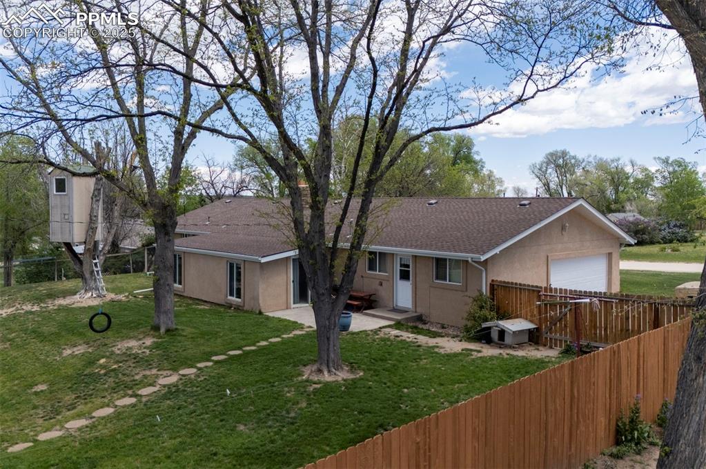 427 Ute Avenue Simla, CO 80835 - Photo 43 of 49 a view of a yard in front of a house with a large tree
