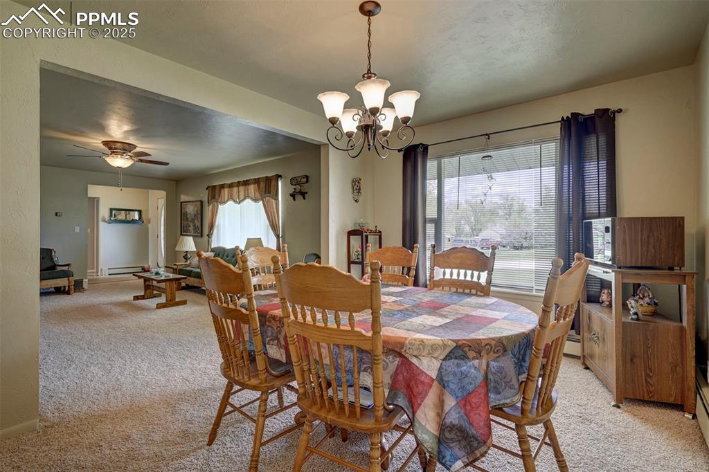 427 Ute Avenue Simla, CO 80835 - Photo 10 of 49 a view of a dining room with furniture a chandelier and wooden floor