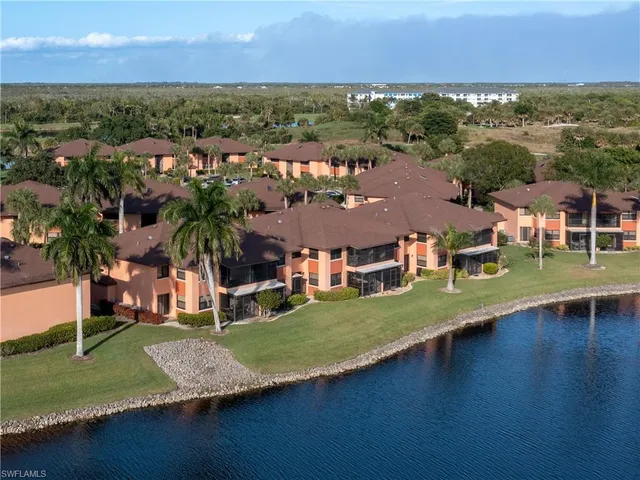 an aerial view of residential houses with outdoor space and river