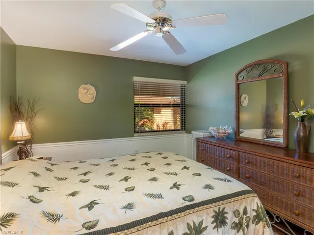 a bedroom with a bed and a dresser in it