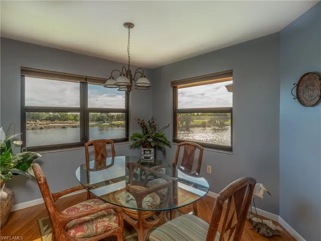 a dining room with furniture a window and a chandelier