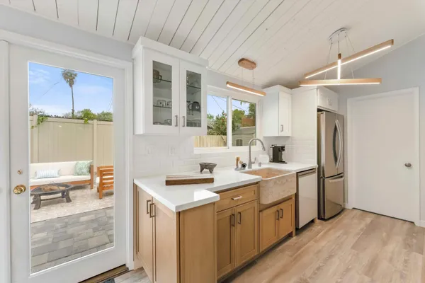 a kitchen with a sink appliances and cabinets
