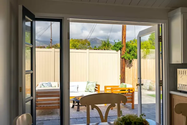 a front view of a house with a garden and outdoor seating