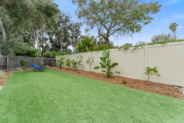 a view of a house with a tree in a yard