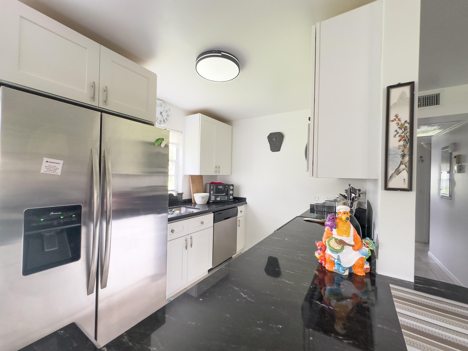 127 Mansfield D Boca Raton, FL 33434 - Photo 11 of 27 a kitchen with stainless steel appliances granite countertop a refrigerator and a stove