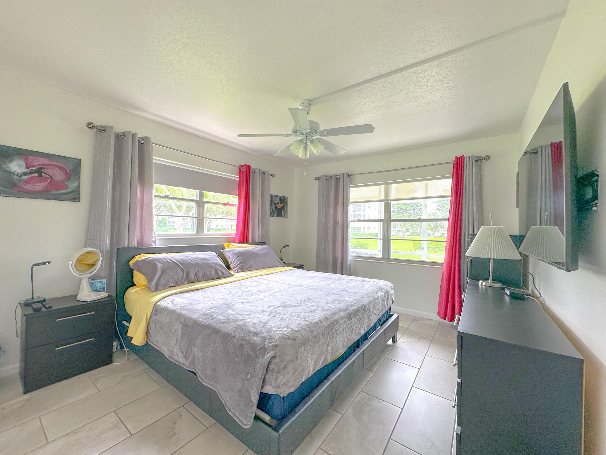 127 Mansfield D Boca Raton, FL 33434 - Photo 12 of 27 a bedroom with a bed and a flat tv screen on dresser