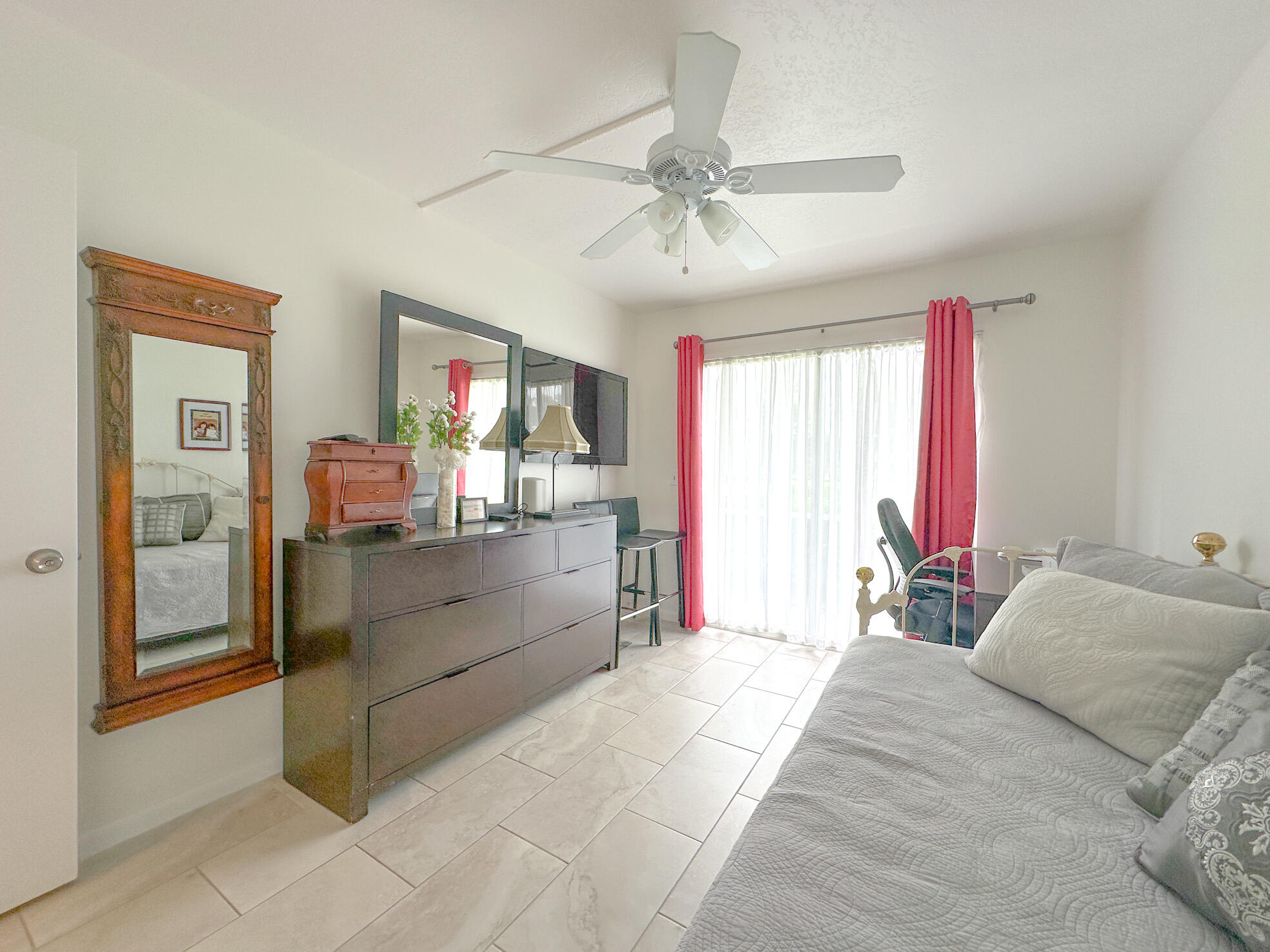 127 Mansfield D Boca Raton, FL 33434 - Photo 14 of 27 a bedroom with a bed and a chandelier
