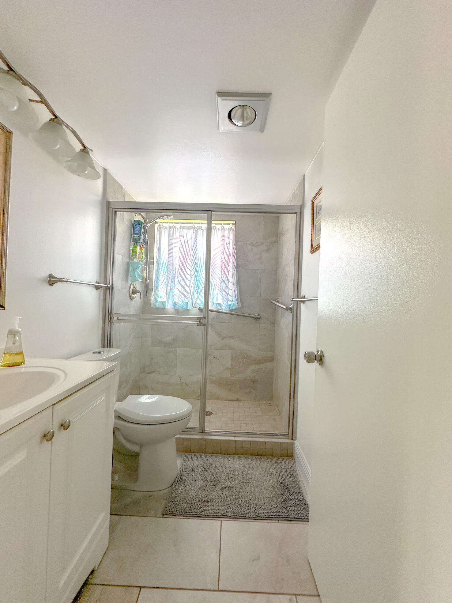 127 Mansfield D Boca Raton, FL 33434 - Photo 16 of 27 a bathroom with a granite countertop sink a toilet and a shower