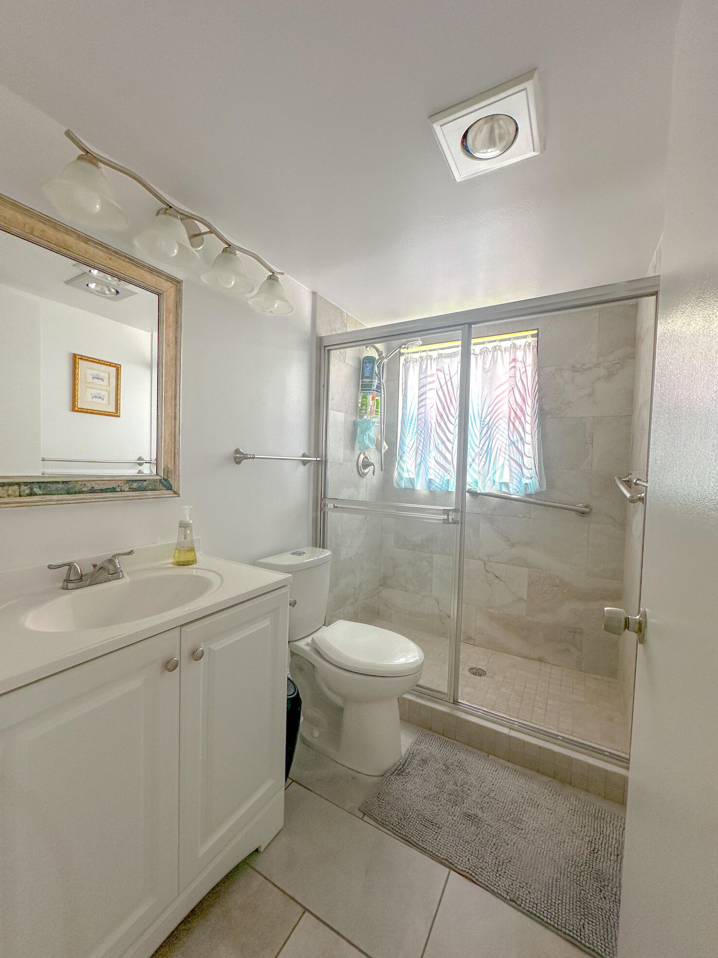 127 Mansfield D Boca Raton, FL 33434 - Photo 17 of 27 a bathroom with a toilet sink and mirror