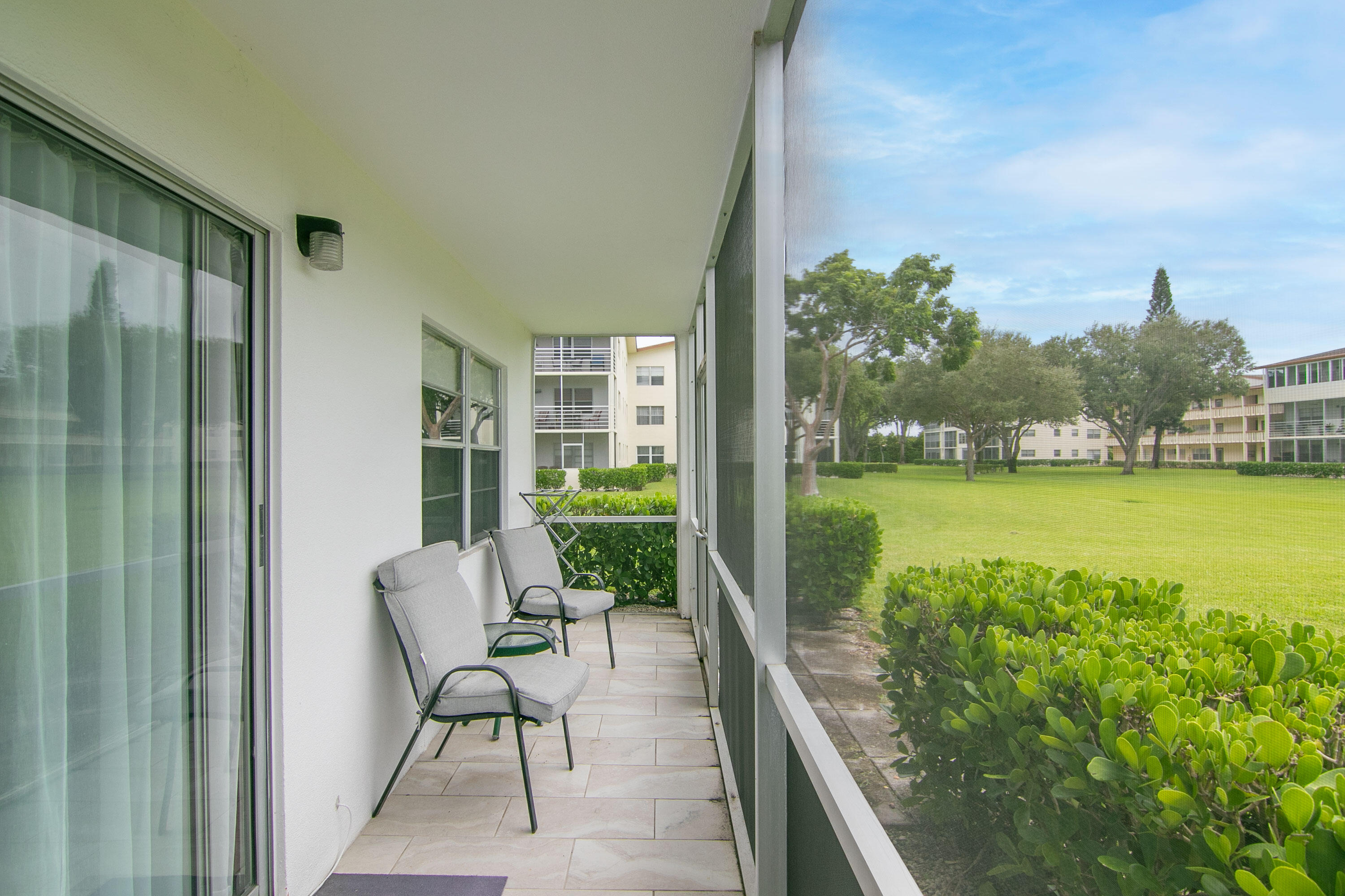 127 Mansfield D Boca Raton, FL 33434 - Photo 19 of 27 a view of a balcony with chair and table in the balcony