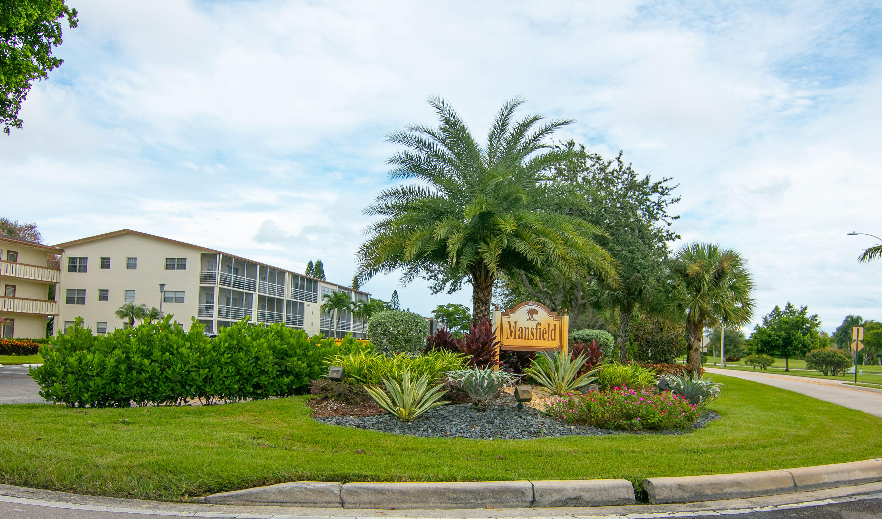 127 Mansfield D Boca Raton, FL 33434 - Photo 27 of 27 a front view of multi story residential apartment building with yard and green space