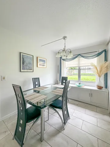 a view of a dining room with furniture and window