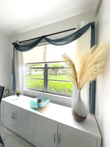 a bathroom with a sink and a large window