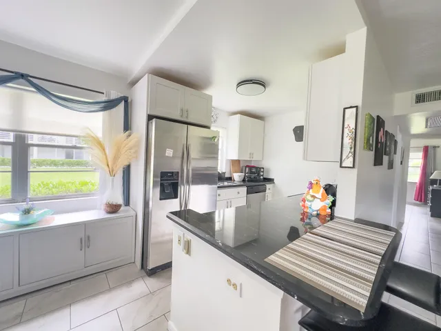a kitchen with sink refrigerator and window