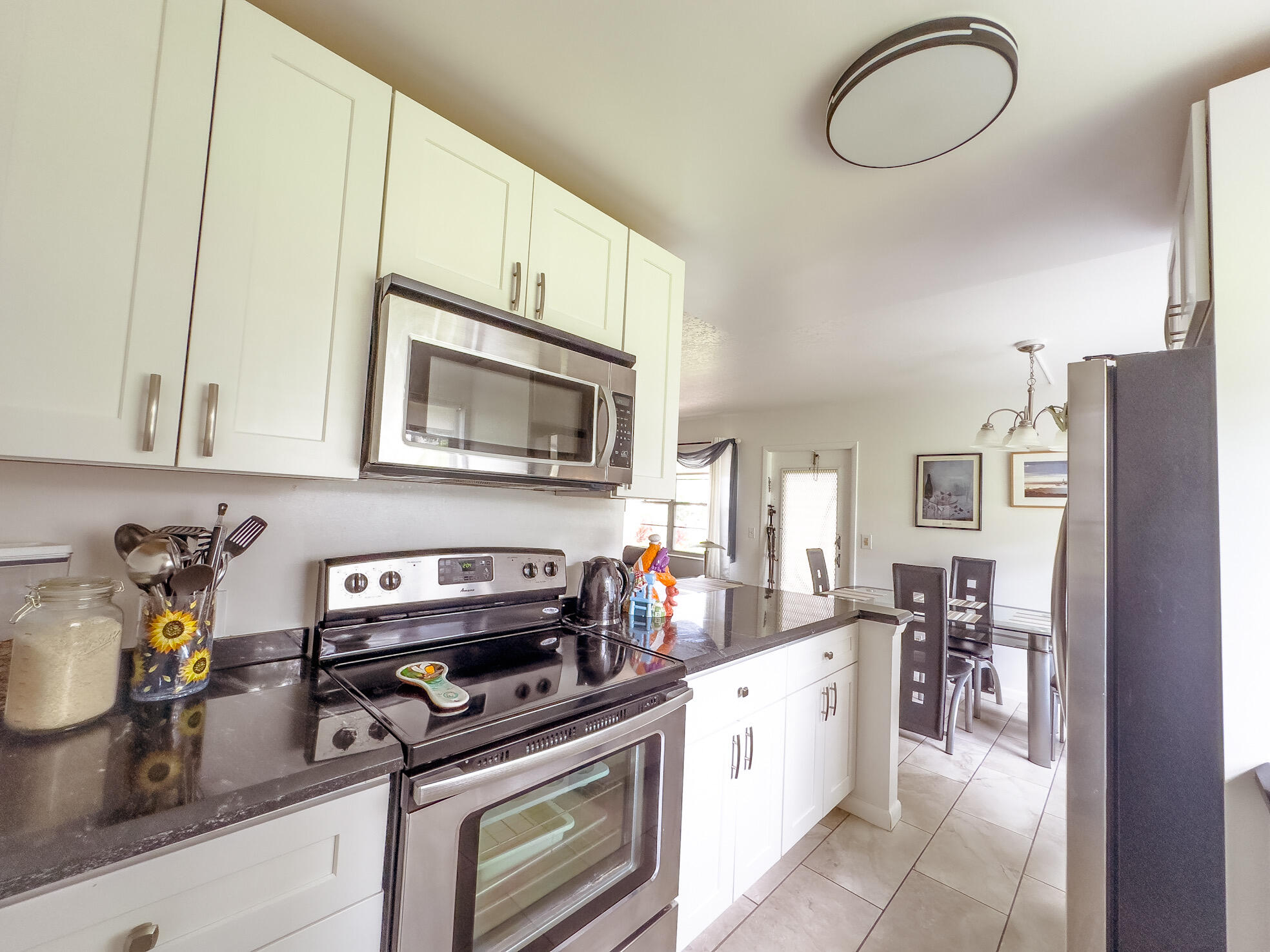 127 Mansfield D Boca Raton, FL 33434 - Photo 8 of 27 a kitchen with stainless steel appliances granite countertop a stove and a sink