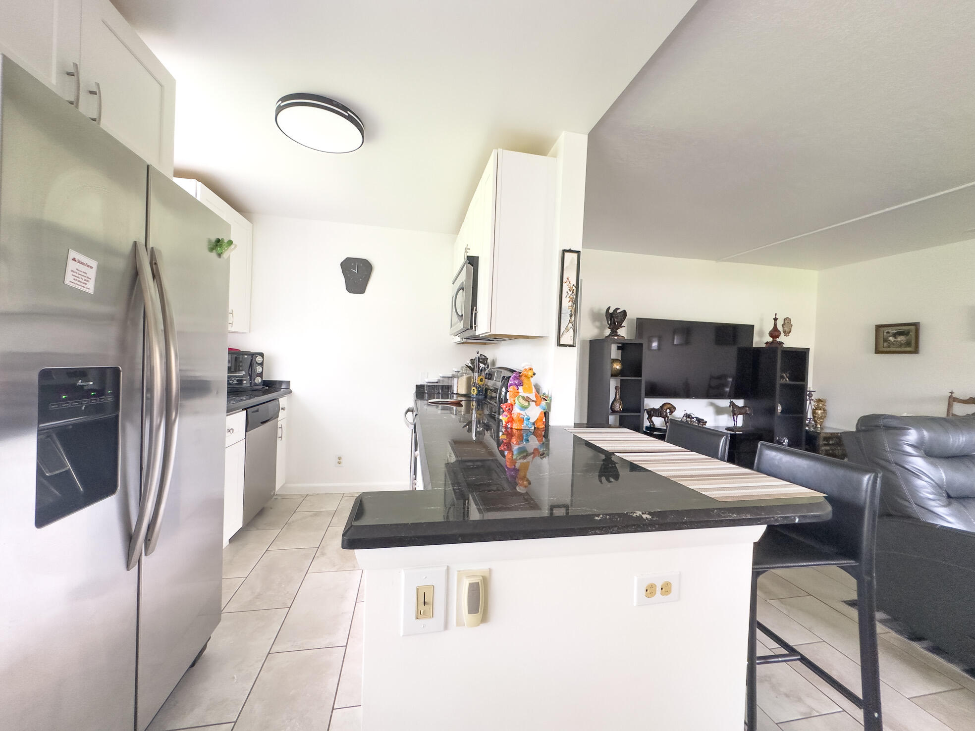 127 Mansfield D Boca Raton, FL 33434 - Photo 10 of 27 a kitchen with stainless steel appliances granite countertop a sink a stove and refrigerator