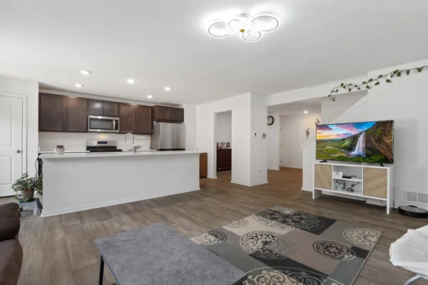 a large kitchen with stainless steel appliances granite countertop a large counter top and a stove top oven