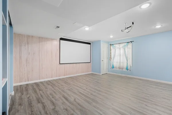a view of a livingroom with wooden floor and a ceiling fan
