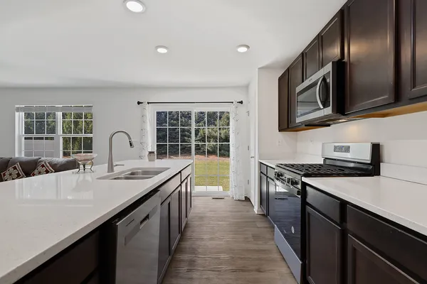 a kitchen with stainless steel appliances granite countertop a sink stove and oven