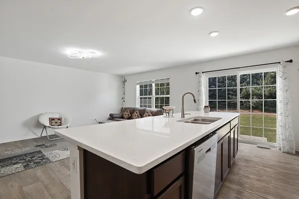 a kitchen with a stove a sink and a refrigerator