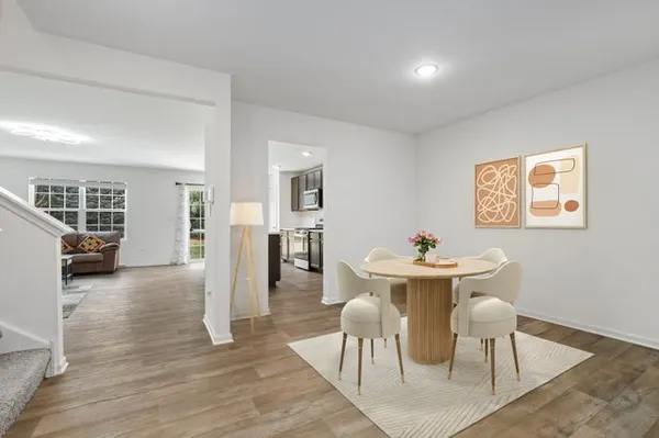 a view of a dining room with furniture and wooden floor