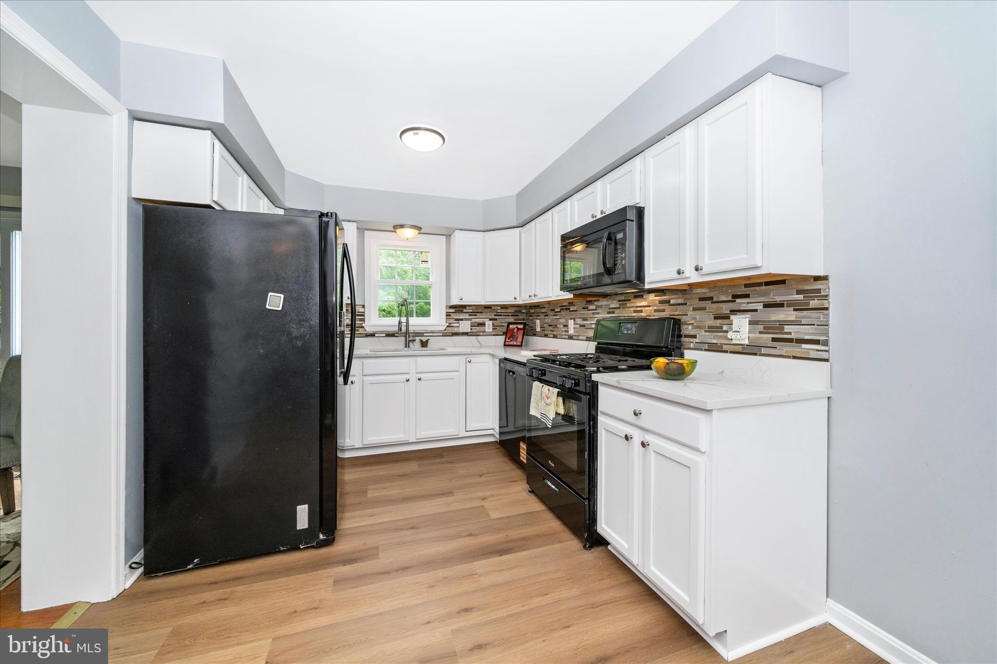 713 Seek Lane Silver Spring, MD 20912 - Photo 5 of 60 a kitchen with a refrigerator stove and sink