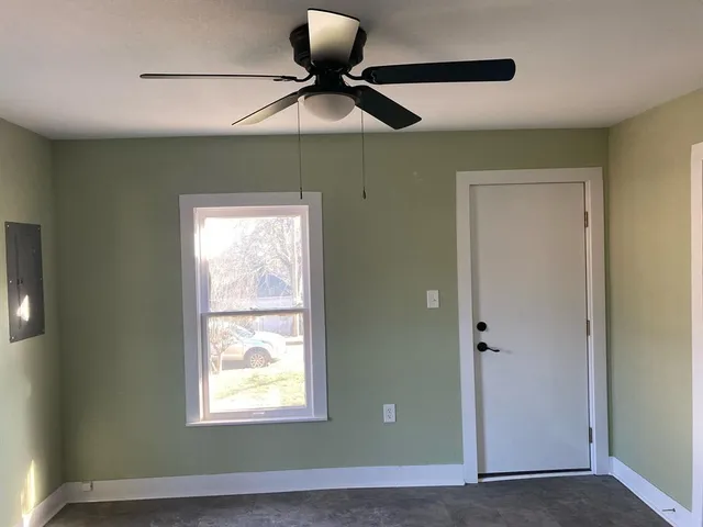 a view of room with window and ceiling fan