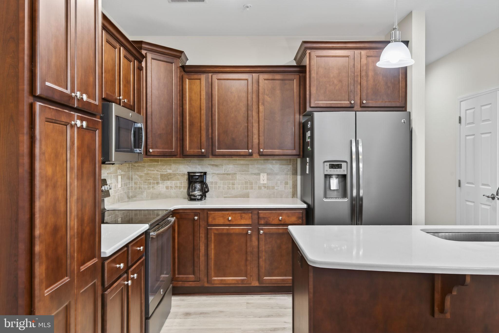 1334 Woodcrest Court Mount Joy, PA 17552 - Photo 8 of 37 a kitchen with stainless steel appliances a refrigerator and a sink