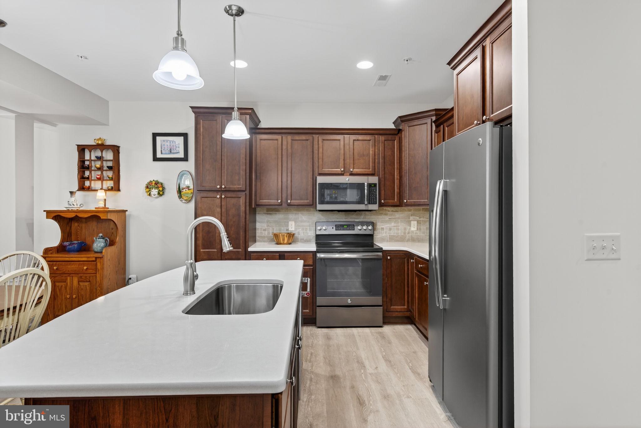 1334 Woodcrest Court Mount Joy, PA 17552 - Photo 9 of 37 a kitchen with stainless steel appliances granite countertop a refrigerator a sink a stove and oven