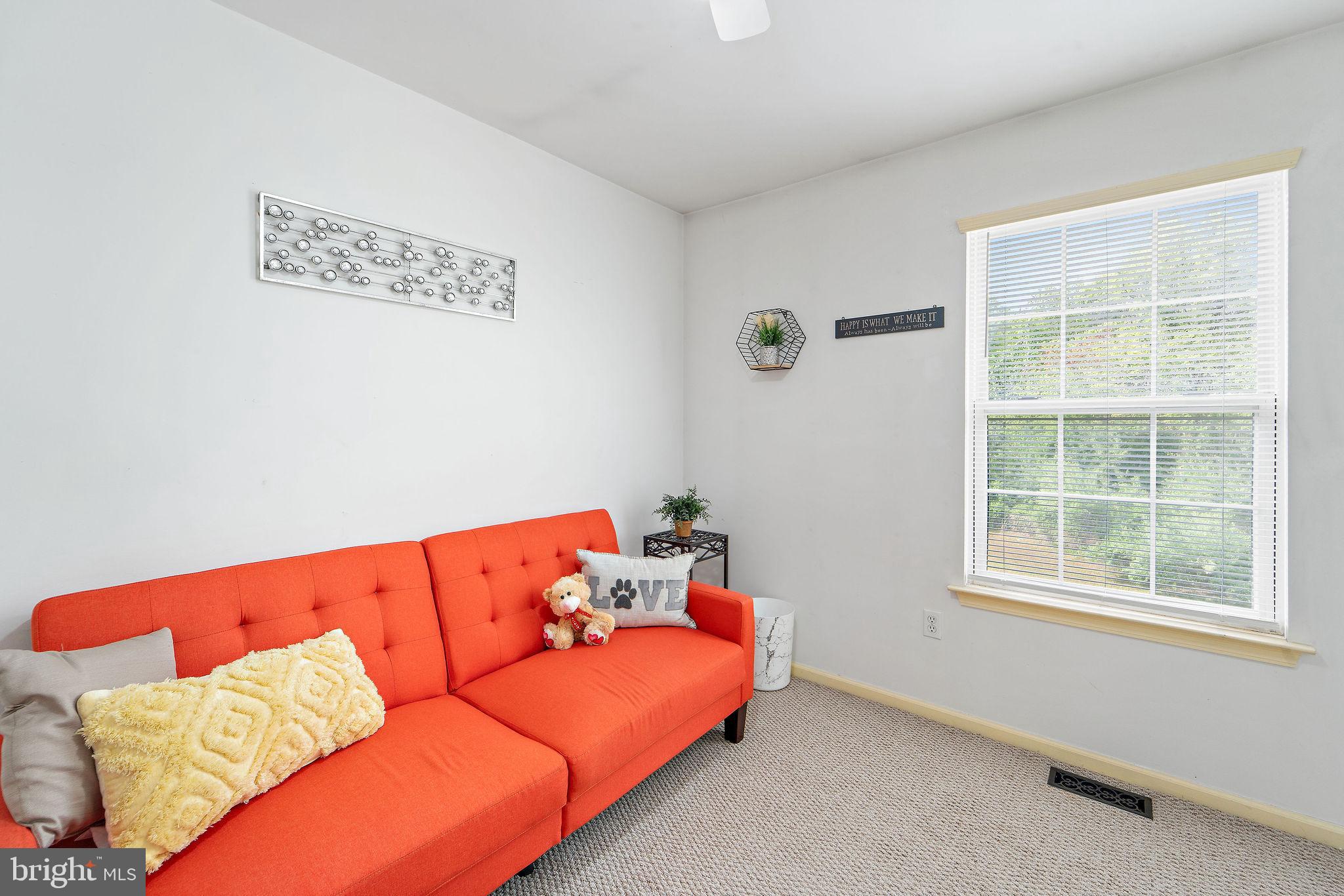 96 High Meadows Drive Sicklerville, NJ 08081 - Photo 16 of 20 a blue couch sitting in a living room next to a window