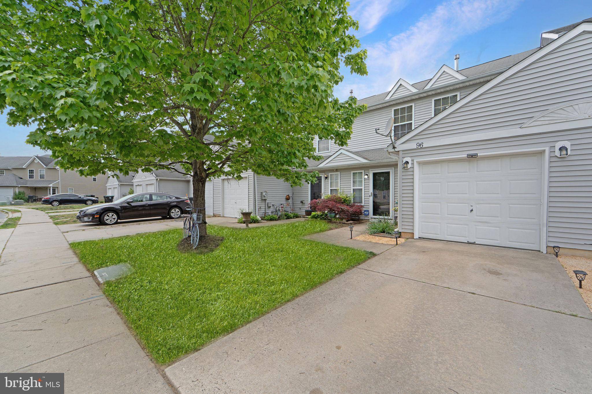 96 High Meadows Drive Sicklerville, NJ 08081 - Photo 3 of 20 a front view of a house with a garden and trees
