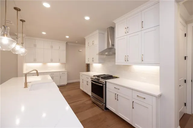 a kitchen with white cabinets and appliances