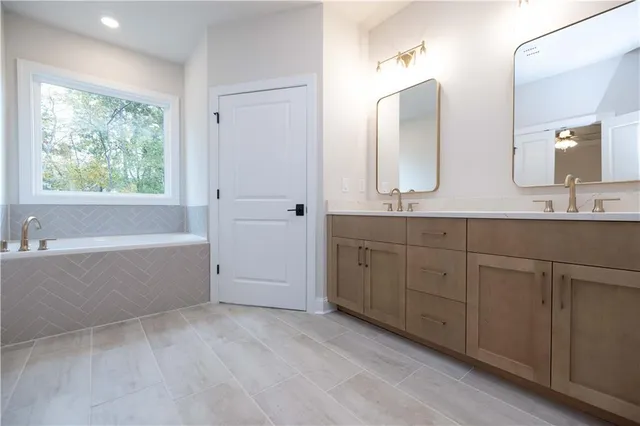a spacious bathroom with a shower sink and mirror