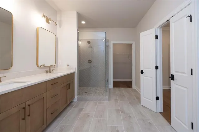 a bathroom with a shower sink and mirror