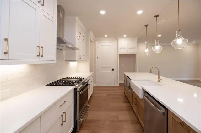 a kitchen with a sink stove and cabinets