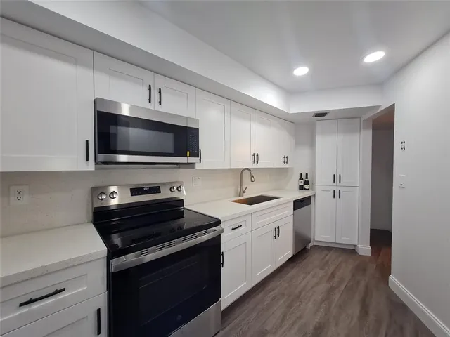a kitchen with a stove and a microwave