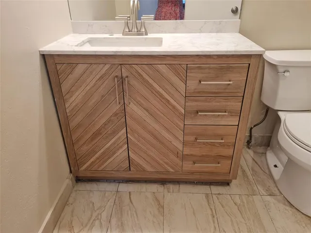 a bathroom with a sink and toilet