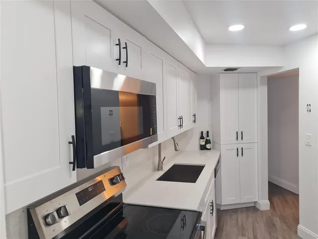 a kitchen that has a sink and a stove in it