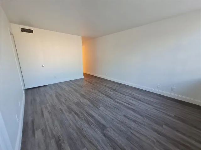 an empty room with wooden floor