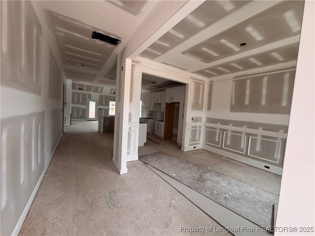 653 Watauga Lane Aberdeen, NC 28315 - Photo 12 of 38 a view of a hallway with wooden shelves